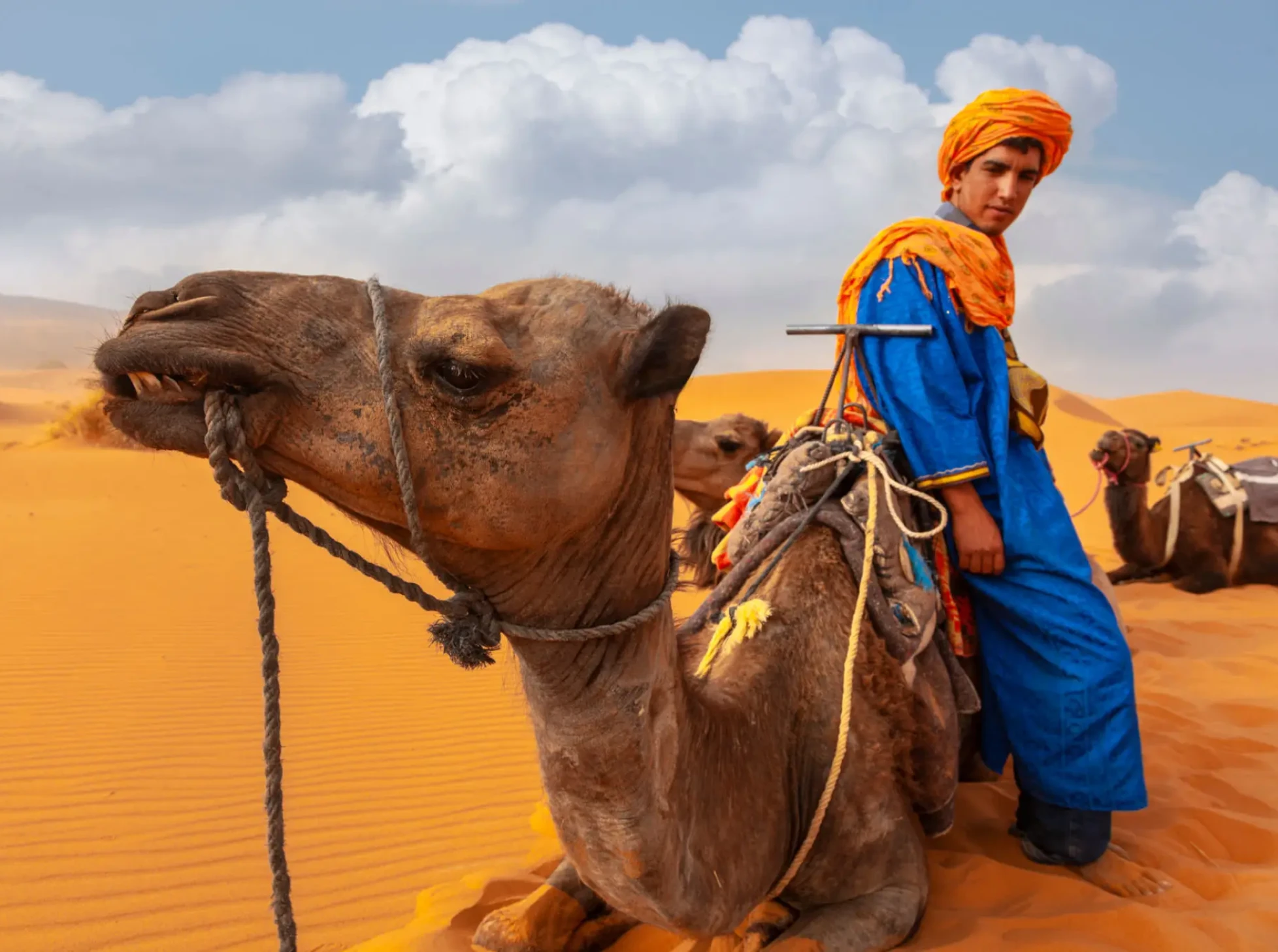 Man in traditional attire with camel