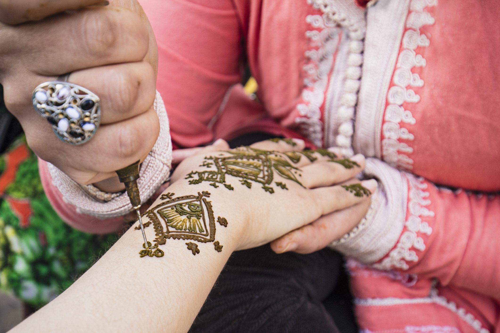 Woman painting henna on the hand in Fez, Morocco.